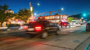 Cars driving down the main road in Moab during dusk - Moab Giants